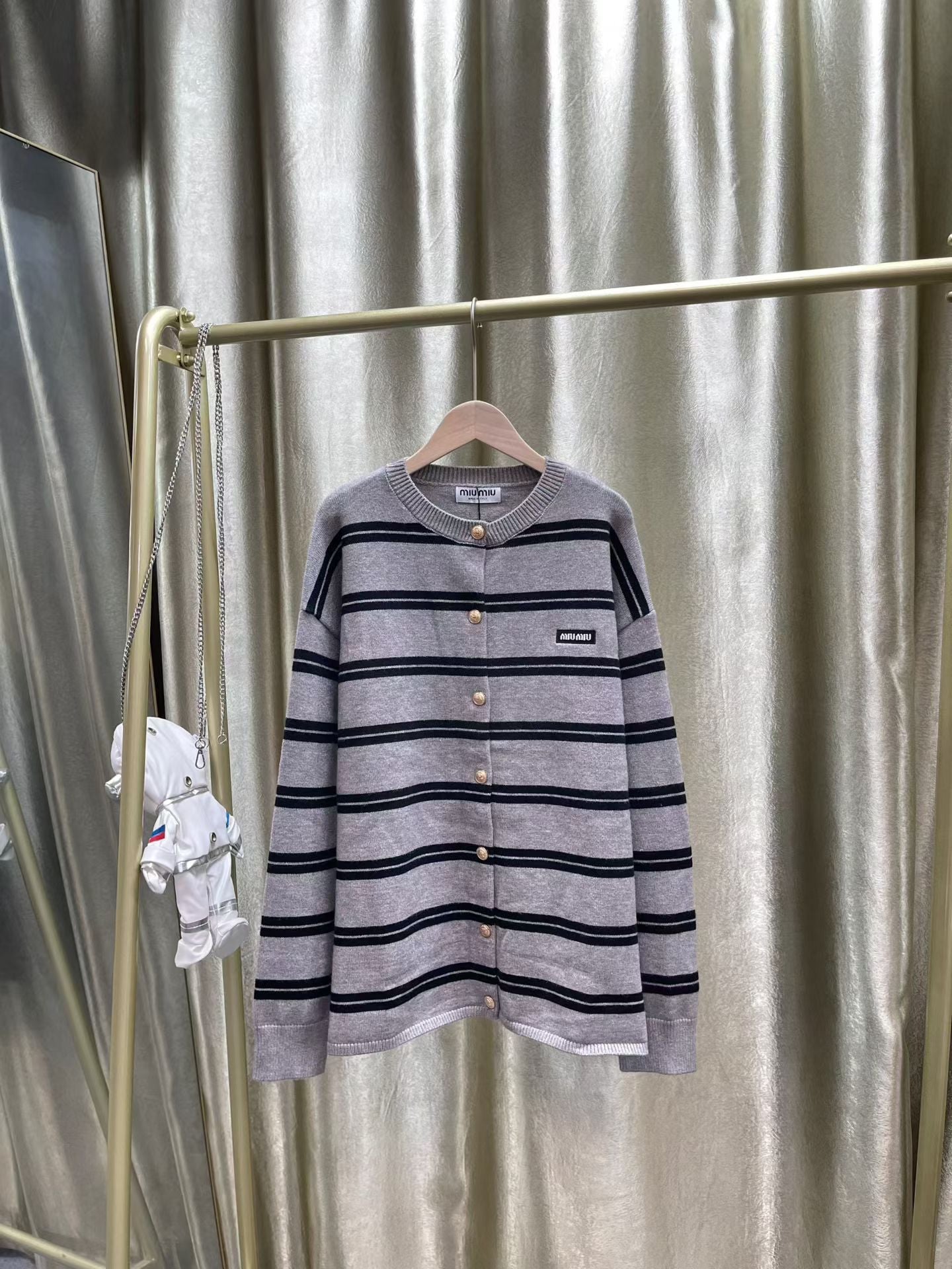 ** Miu Miu Striped Cardigan Sweater with Embroidered Logo

**