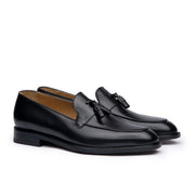 Mens tassel loafers in black full grain calfskin leather with suede finish at the heel cap